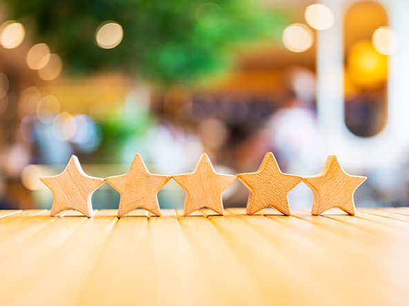 five wooden star block shapes on table with a blurred background